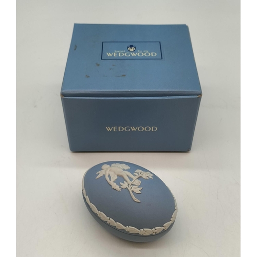 212 - Boxed Wedgwood Jasper Egg Trinket with Cherub Decoration. 5cm High, 7cm x 5cm.