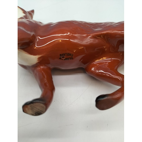 105 - Beswick Model of a Standing Fox. 13cm High, 24cm Long.