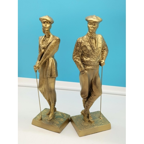 155 - Austin 41cm Sculptures of a Male and a Female Golfer. Signed.