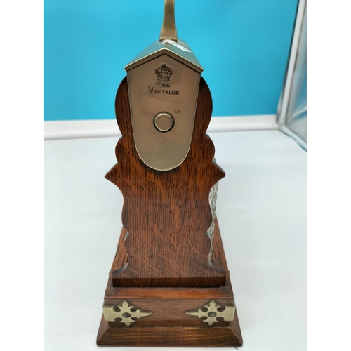 16 - Oak Tantalus with Silver Plate and Brass Embellishments. Requires Key. 32cm High, 39cm x 14cm.