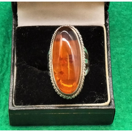 204 - 925 Silver and Amber Ring. Size K. 12.8 Grams including Amber.