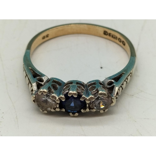 694 - 9ct Gold Clear and Blue Stone Ring. Size O. 2.5 Grams.