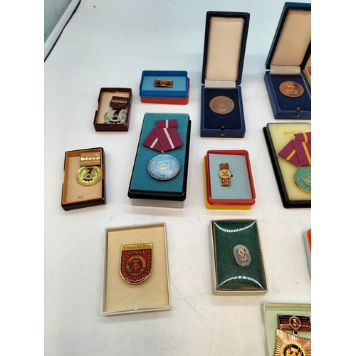 48 - Large Collection of German DDR Awards and Medals including Badges of Honour from the National Front ... 