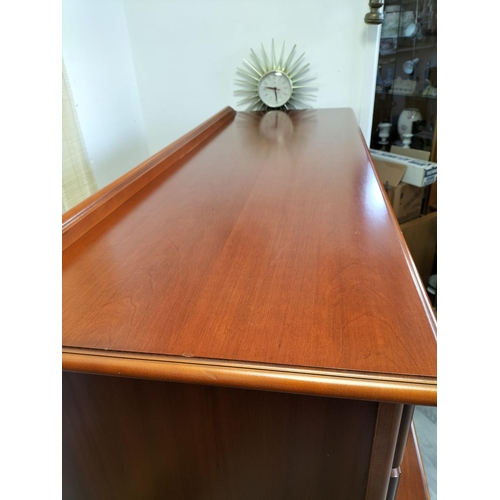 85A - Wooden Chest of 7 Drawers with Brass Handles on Bun Feet. 77cm high, 142cm x 49cm. Collection Only.