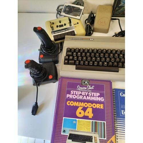 89 - Commodore 64 with Joysticks and Games. Cover Missing on Tape Deck. Powers Up.