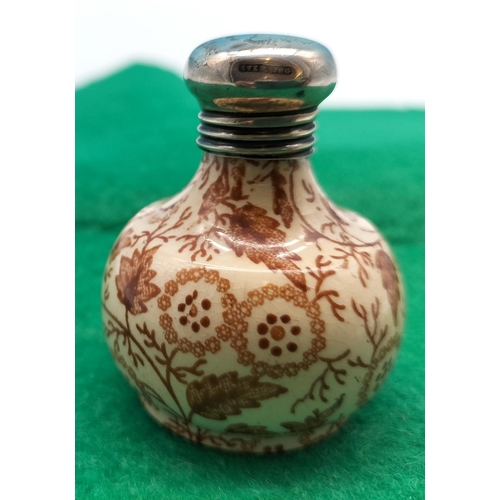 131 - Small 5cm Sterling Silver Topped Ceramic Bottle.