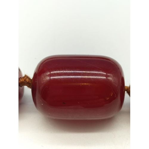 104 - c1920's Art Deco Red Cherry Amber Necklace. 44cm Long. Largest Bead 3cm x 2cm. Weight 76 Grams. Jewe... 