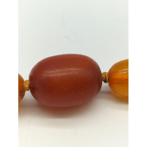 105 - c1920's Art Deco Yellow/Natural Amber Necklace. 31cm Long. Largest Bead 2cm x 1.5cm. Weight 20 Grams... 