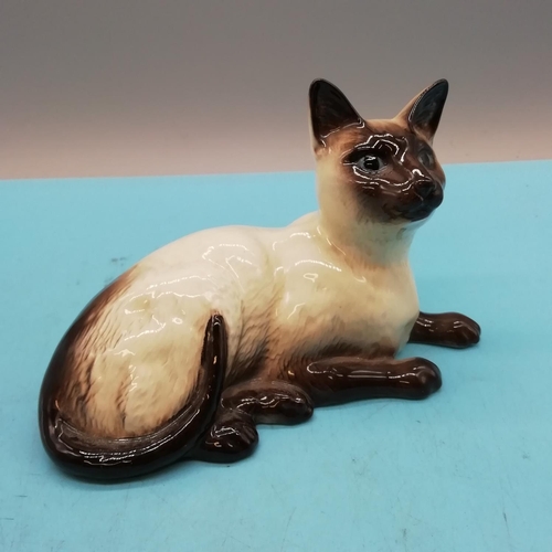 438 - Royal Doulton Figure of a Siamese Cat Lying Down. 12cm High x 19cm.