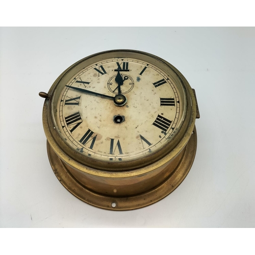 45 - Ship's Porthole Wind Up Clock. 19cm Diameter. Requires Key.