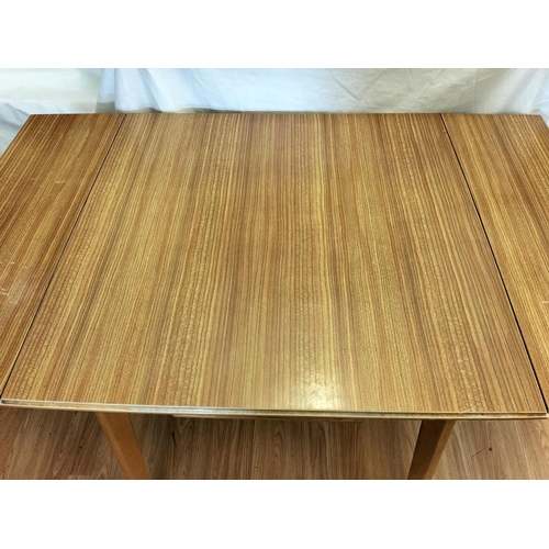 607 - Formica Top Extending Dining Table. 77cm High, 126cm x 68cm. Collection Only.