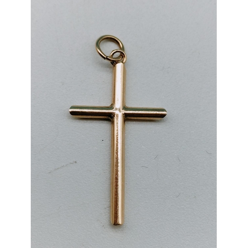 169 - Gold Cross Pendant. 3cm x 1.5cm. 0.8 Grams. Vendors Description.