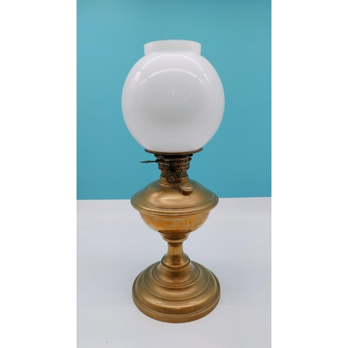 557 - Brass Oil Lamp with Globe Shade. Requires Funnel. 50cm Tall.