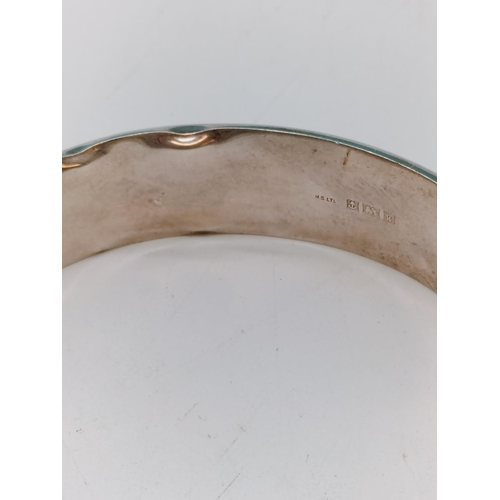 22 - Silver Hallmarked Bangle with Gold Plated Flower Design. 25 Grams. Dent to Rim.