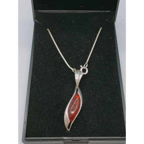 588 - 925 Silver and Amber Pendant on 925 Silver Chain.