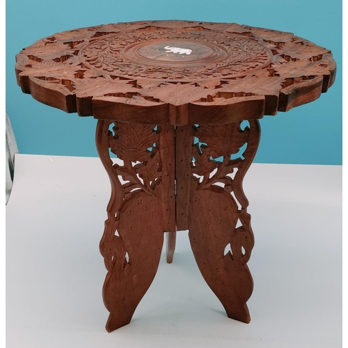 729 - Carved Wooden Table Inlaid with Elephant Motif. 38cm High, 37cm Diameter. Collection Only.