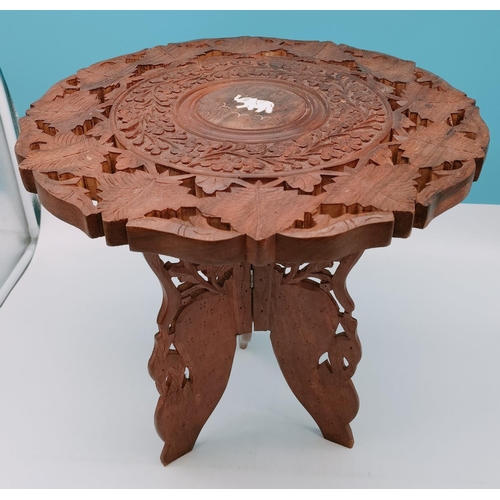 729 - Carved Wooden Table Inlaid with Elephant Motif. 38cm High, 37cm Diameter. Collection Only.