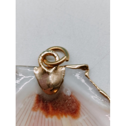 175 - Shell Pendant with Gold Tone Rim.