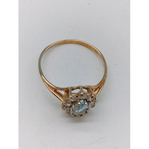 405 - 9ct Gold Ring with Aquamarine and Cubic Zirconia. 1.6 Grams. Size O+