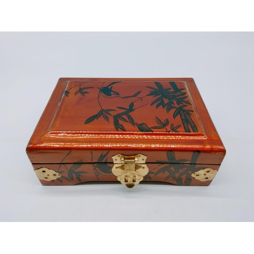 314 - Lacquered Chinese Jewellery Box with Bamboo and Bird Design. 7cm High, 19cm x 14cm.