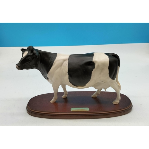 21 - Royal Doulton Figure of a Friesian Cow on Plinth. 20cm High, 31cm x 12cm. Seconds Quality.