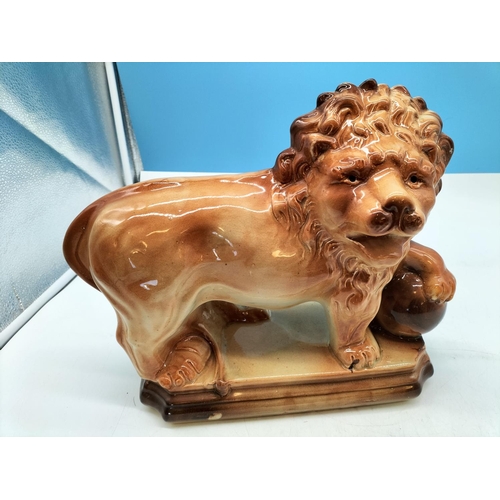 36 - Lancaster & Sons 1920's Ceramic Figure of a Lion on Plinth with Claw on Ball. 29cm High, 37cm x 13cm... 