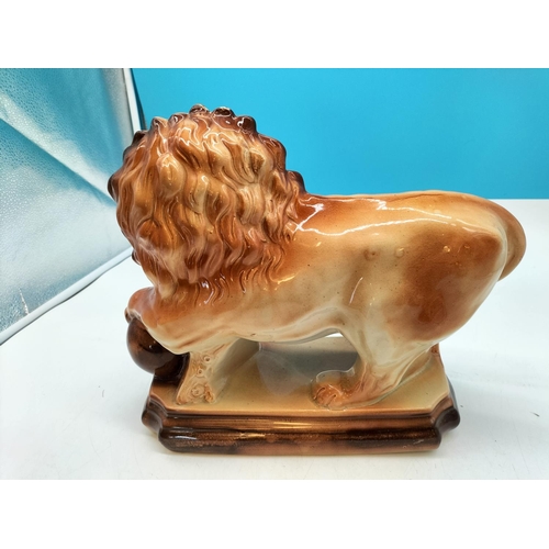 36 - Lancaster & Sons 1920's Ceramic Figure of a Lion on Plinth with Claw on Ball. 29cm High, 37cm x 13cm... 