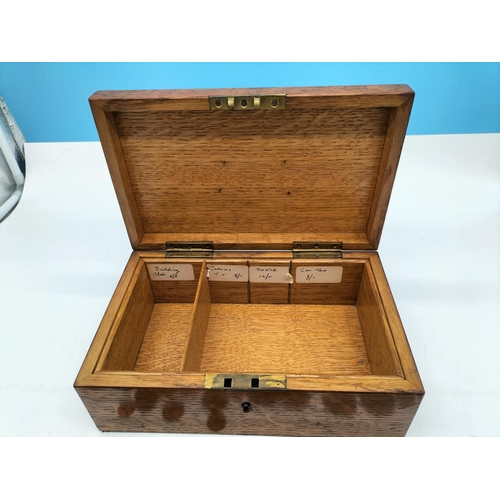 71 - Oak Box with Brass Handle and Quantity of Coins. Requires Key. 11cm High, 27cm x 16.5cm.