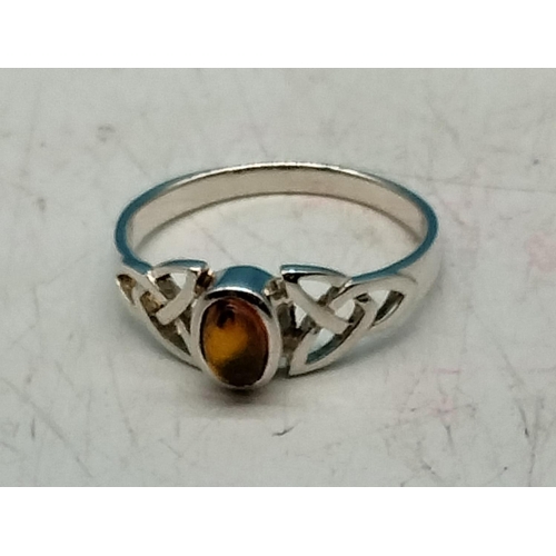 572 - 925 Silver Celtic Design Ring set with Amber. Size Q.