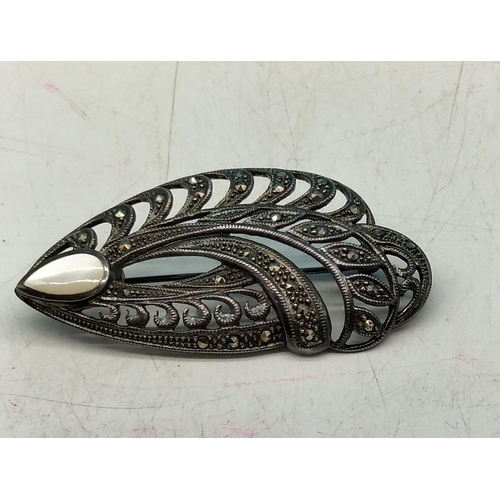 574 - White Metal Brooch set with Marcasite and Mother of Pearl.