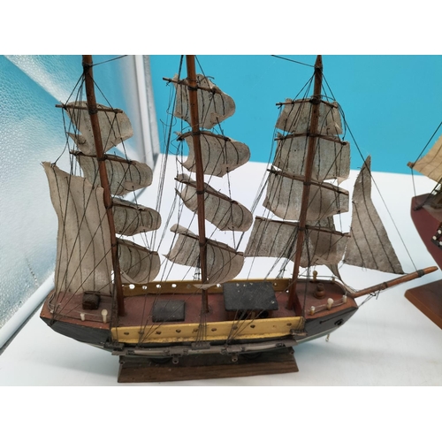 584 - Wooden Galleon Ships on Stands (2). Largest 40cm high, 43cm x 7cm.