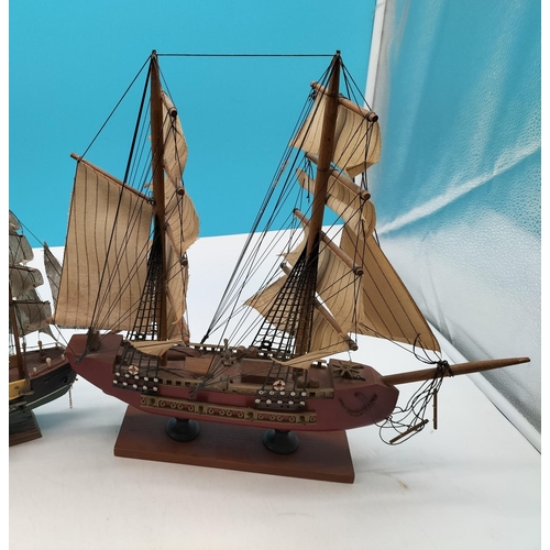 584 - Wooden Galleon Ships on Stands (2). Largest 40cm high, 43cm x 7cm.