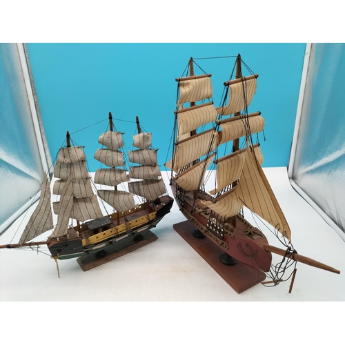 584 - Wooden Galleon Ships on Stands (2). Largest 40cm high, 43cm x 7cm.