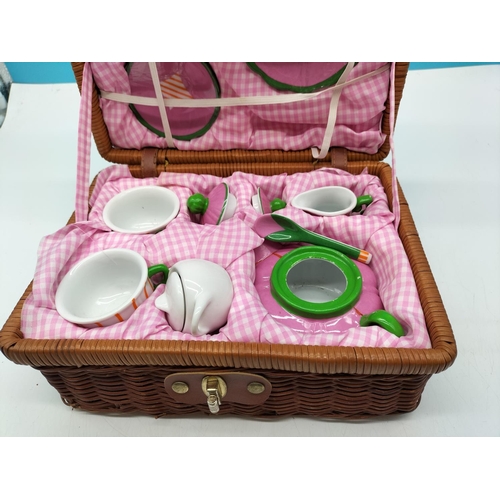 471 - Child's China Tea Set in Wicker Basket. 26cm x 19cm x 13cm.