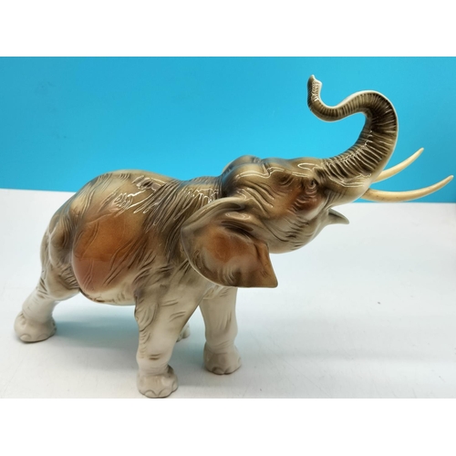 554 - Royal Dux Figure of an Elephant, Trunk Up. 25cm high, 32cm long.