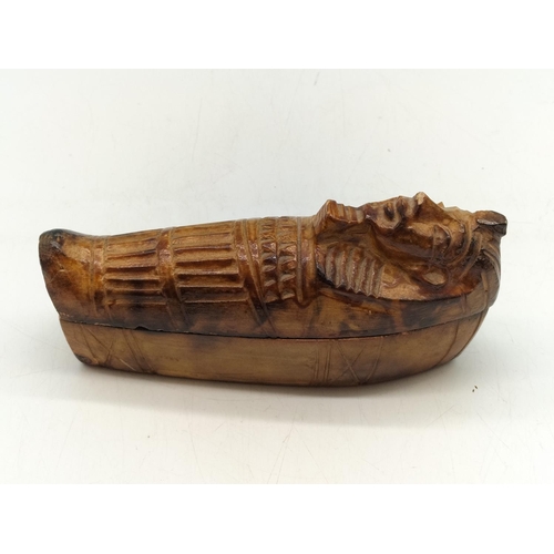 561 - Souvenir Egyptian Mummy in Sarcophagus. 17cm x 5cm x 7cm. Chips to Rims.