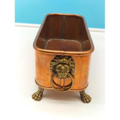 10 - Copper and Brass Window Planter with Lion Head Handles and Claw Feet. 11cm High, 29cm x 12cm.