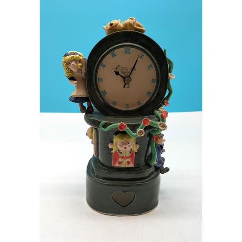 101 - Handmade Ceramic 'Alice in Wonderland' Clock. 29cm high, 12cm x 13cm.