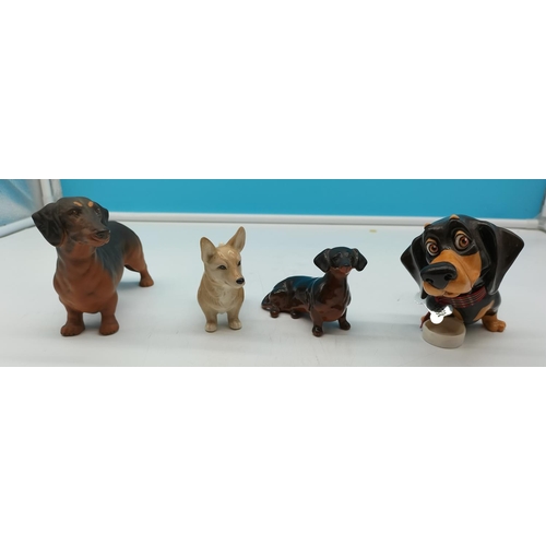 82 - Dog Figures (4) to include Royal Doulton Dachshund Figure, Pets with Personality Figure, Beswick plu... 