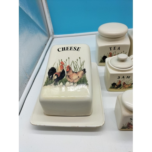 712 - Kitchenware with 'Cock and Hen' design to include Storage Jars, Cheese Dish, Butter Dish, etc.