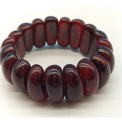 21 - Red Amber Bracelet. 19 Beads each about 2cm x 1cm. Weighs 43.87 grams. Has been Tested by Vendor.