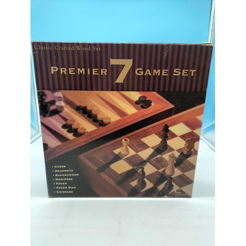 148 - Premier 7 Game Set to include Chess, Draughts, Backgammon, etc. Board measures 34cm x 34cm x 7cm.