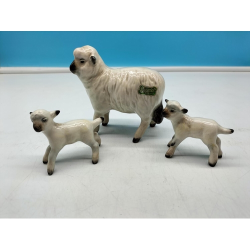 284 - Beswick Figures of a Sheep and Lambs. Largest 9cm x 9cm.