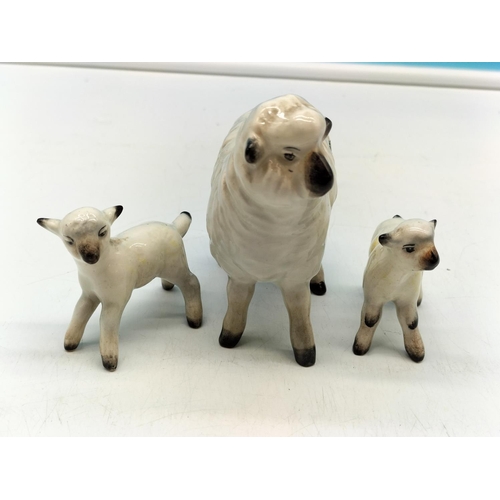 284 - Beswick Figures of a Sheep and Lambs. Largest 9cm x 9cm.