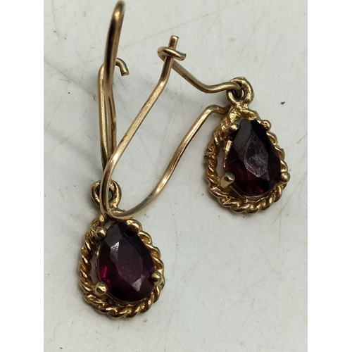 364 - 2 Pairs of Unmarked Tested 9ct Gold Earrings. One with Garnets.