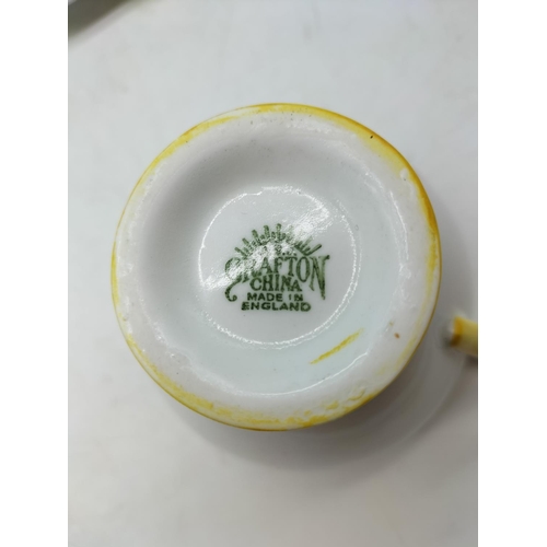 77 - Grafton China 21 Piece Part Tea Set in a Yellow Floral Pattern. 1 Cup A/F, Chip to Rim.