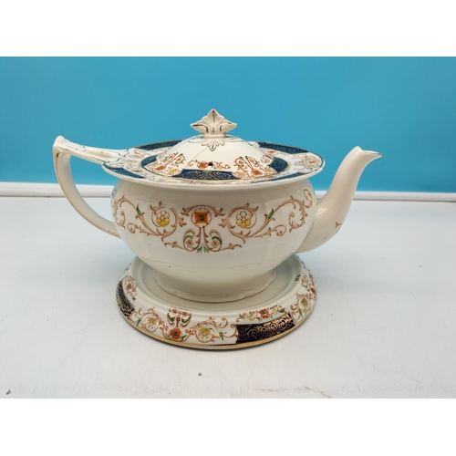 496 - Alfred Meakin Zenith Shape Teapot and Stand in the 'Golden Glory' Pattern.15cm High x 25cm Long. Lid... 