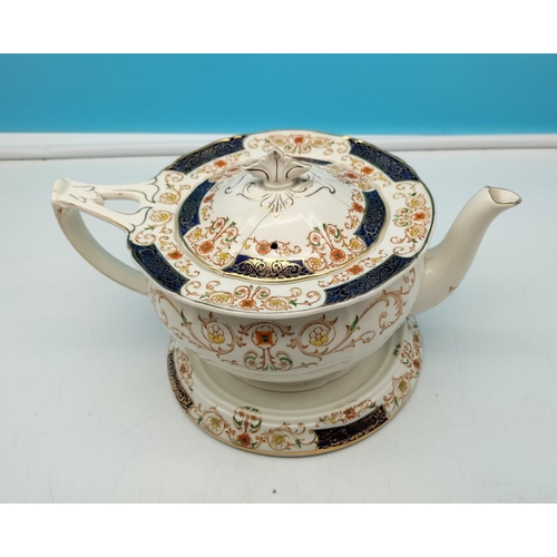 496 - Alfred Meakin Zenith Shape Teapot and Stand in the 'Golden Glory' Pattern.15cm High x 25cm Long. Lid... 