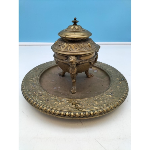 545 - Brass Inkwell on Footed Stand. 17cm High, 24cm Diameter.