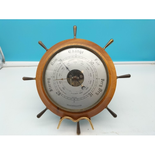 562 - Ships Wheel Weather Master Barometer. 28cm Diameter.